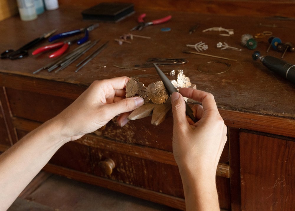 Jieun working on a hair clip at her workbench