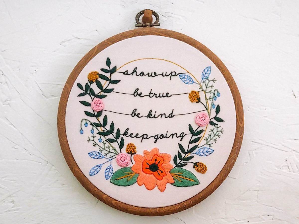 An embroidery hoop from Cozy Blue stitched with the message