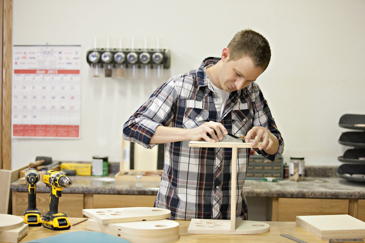 Jesse Bannor in the Bannor Toys workshop, assembling a toy