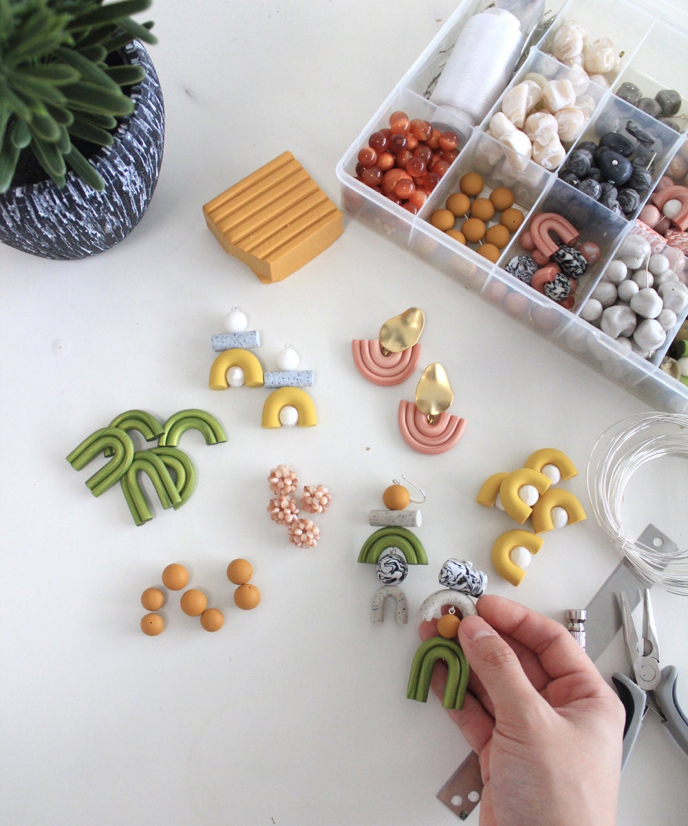 Jessica mixes and matches various colored clay beads to create fun, abstract designs.