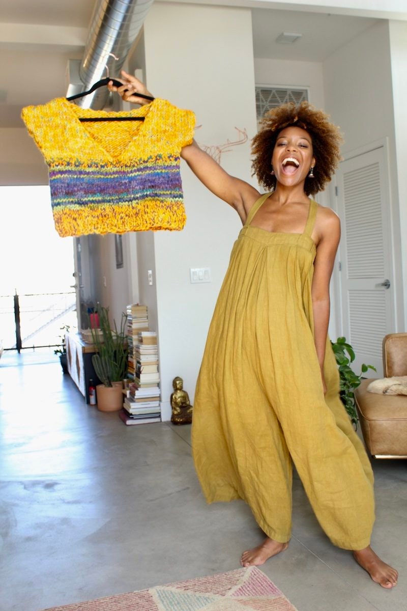 Chasten at home holding one of her sweaters Chasten at home holding one of her sweaters