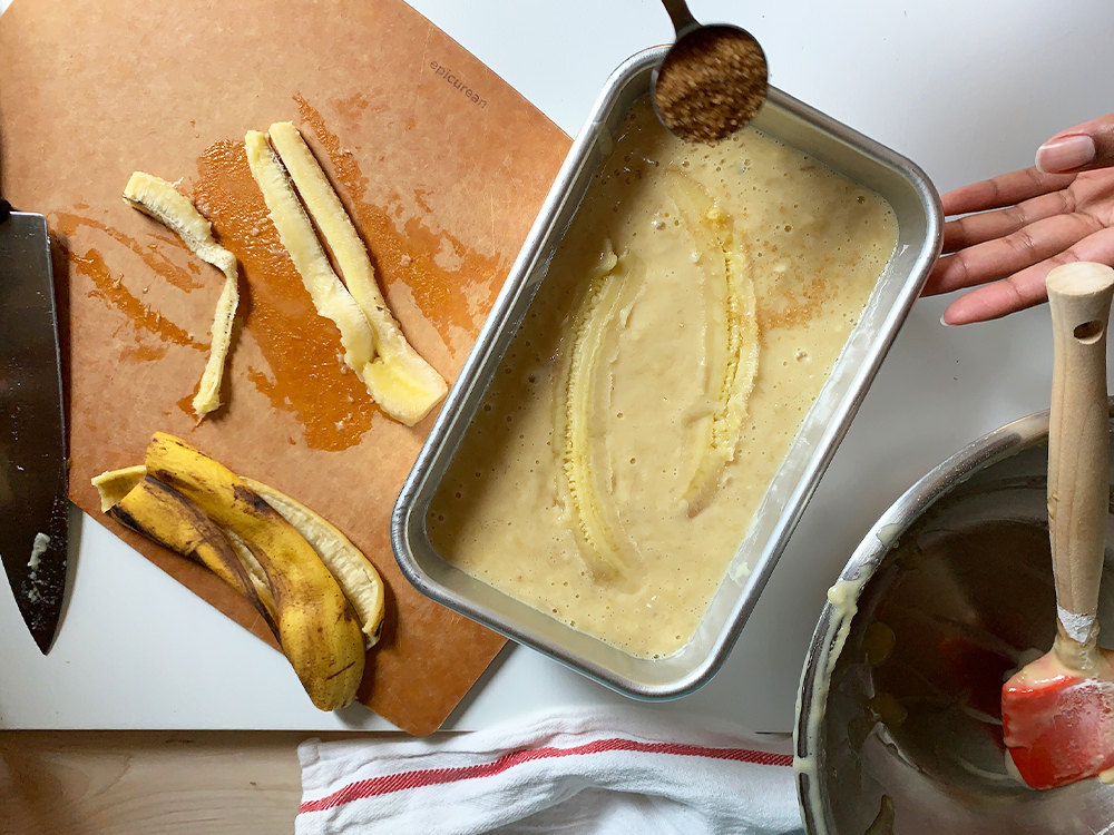 Aravis sprinkling sugar over the top of the prepared batter.