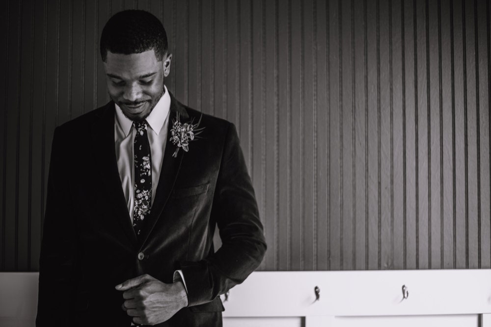 A black and white portrait of Terrell dressed up on his wedding day