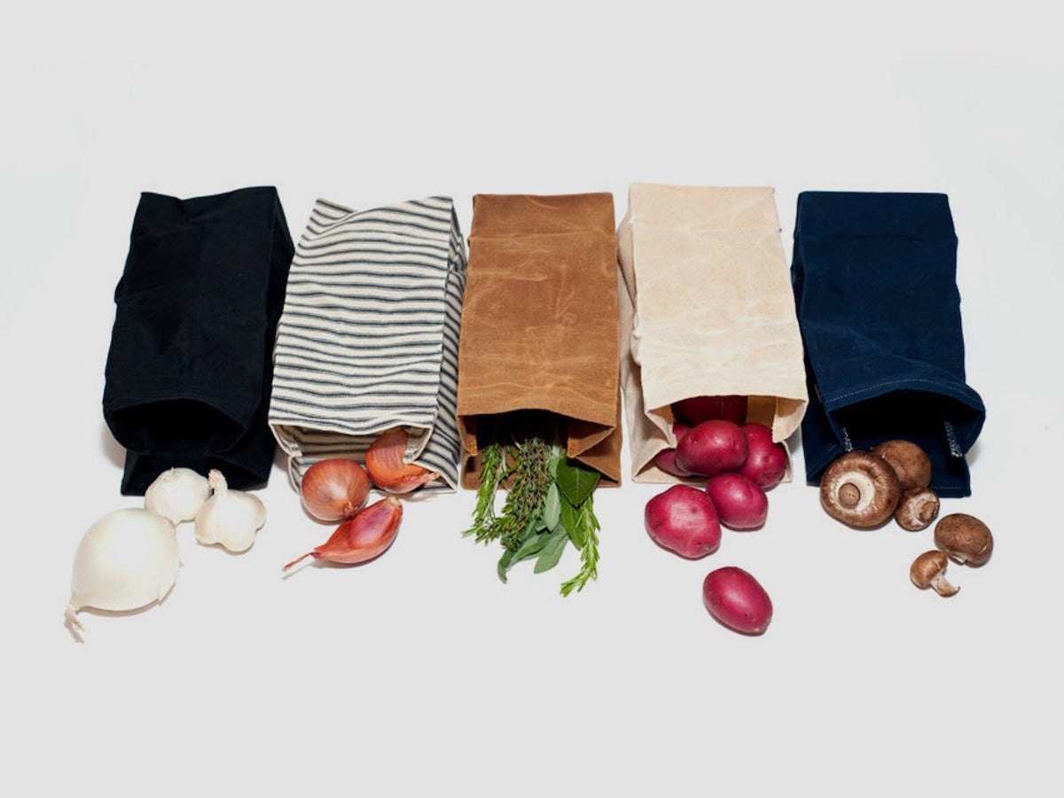 A lineup of waxed canvas produce bags in assorted earthy colors from WAAM Industries