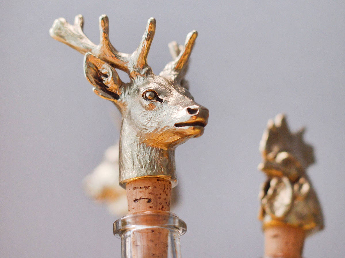Elegant brass bottle stopper sculpted in the shape of a deer head.