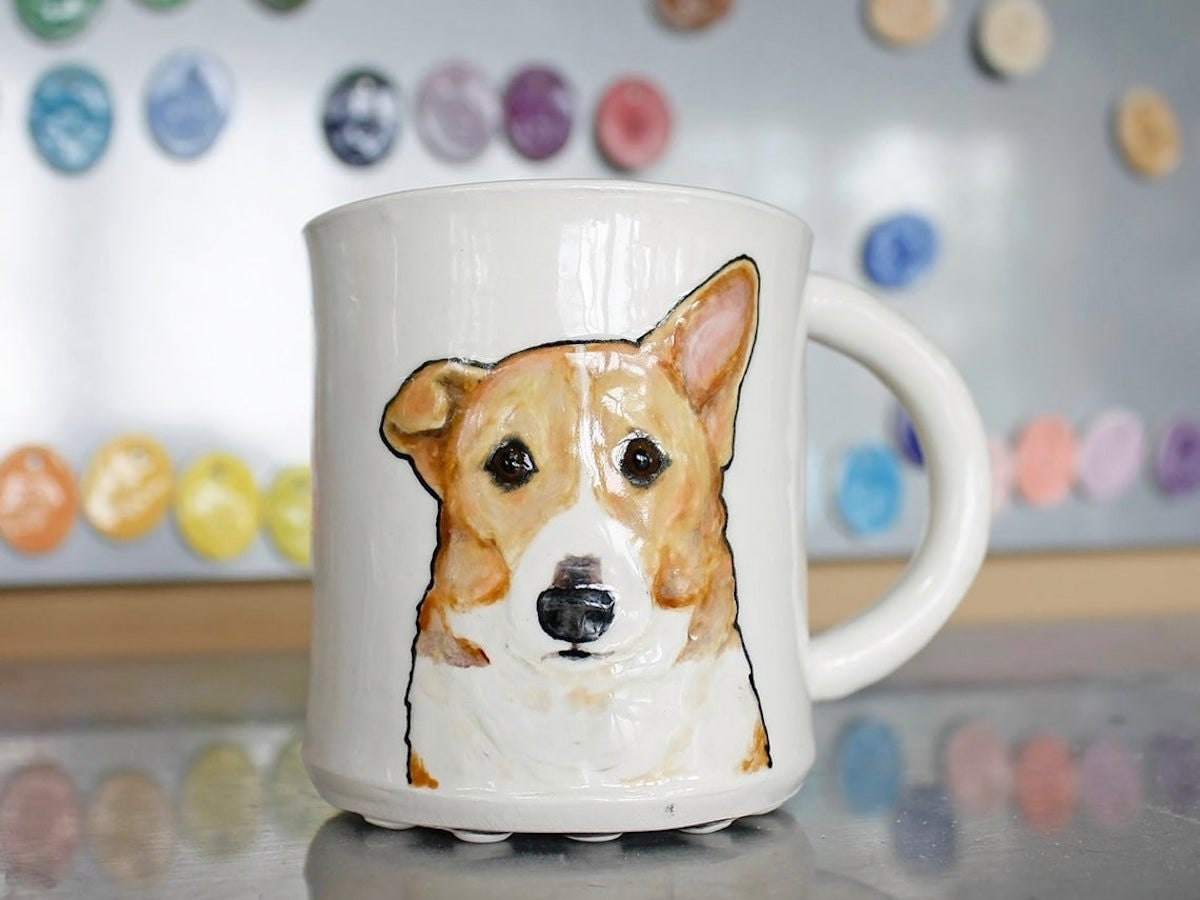 A hand-sculpted pet portrait mug from Hadley Clay featuring a Corgi in 3D relief. One of the 2020 Etsy Design Awards finalists.