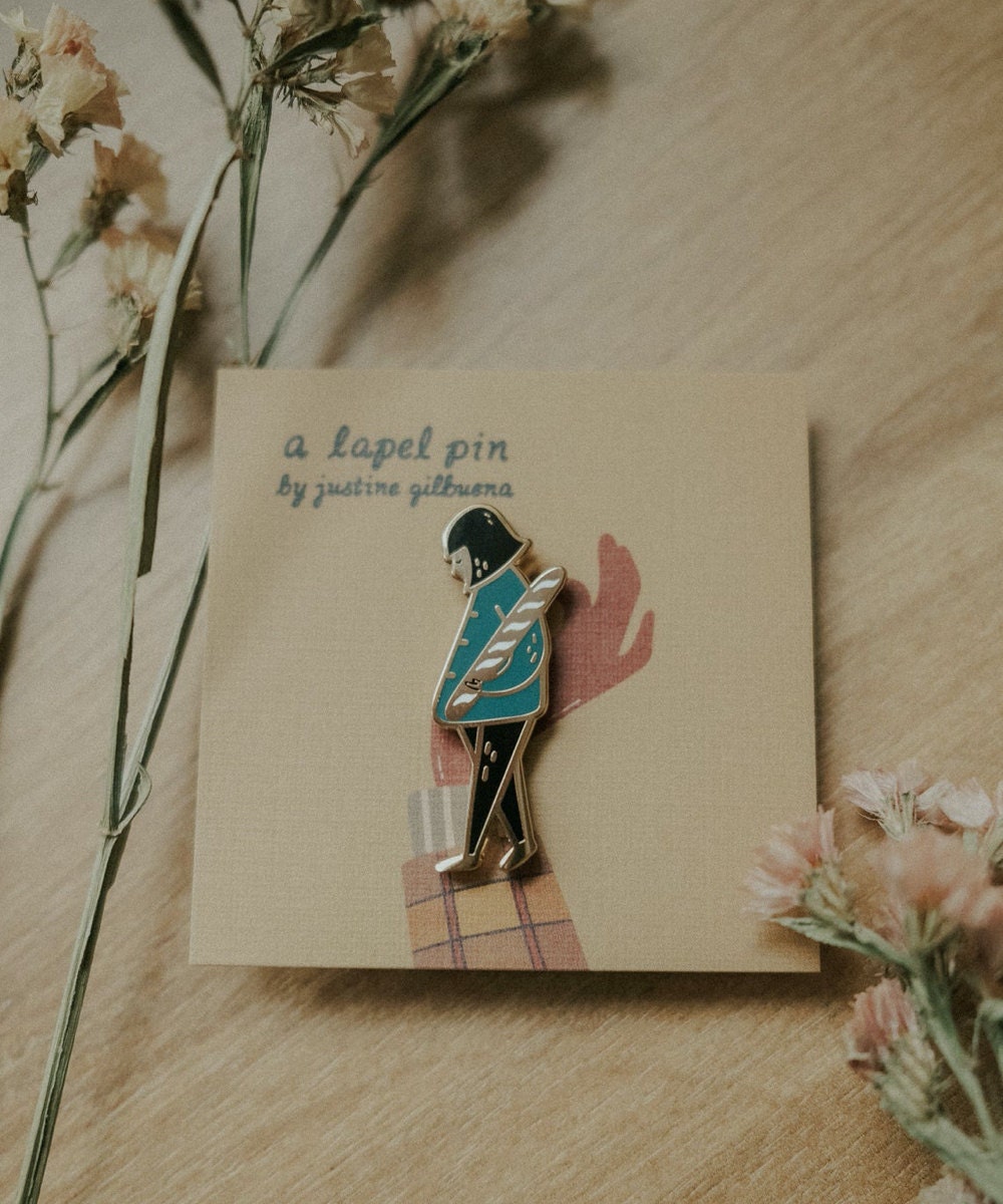 Girl with baguette enamel pin from Justine Gilbuena