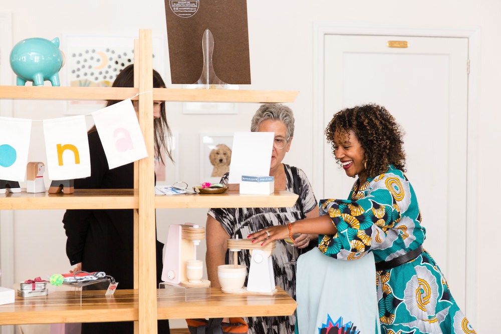 Dayna shows off trendy new Etsy products at a press preview.