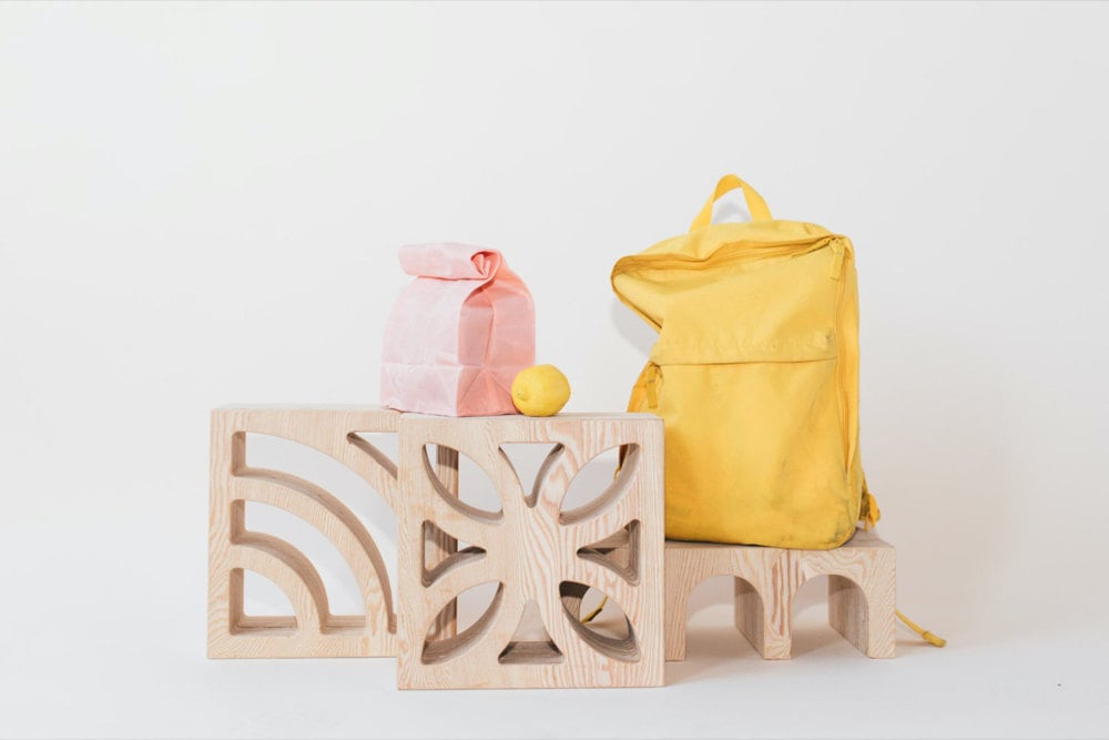 A styled photo of decorative tinder blocks, wine racks, and lunch bags.