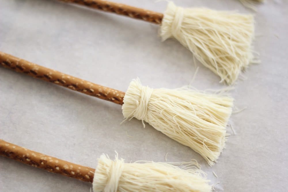 Cut and assembled broomsticks in a row