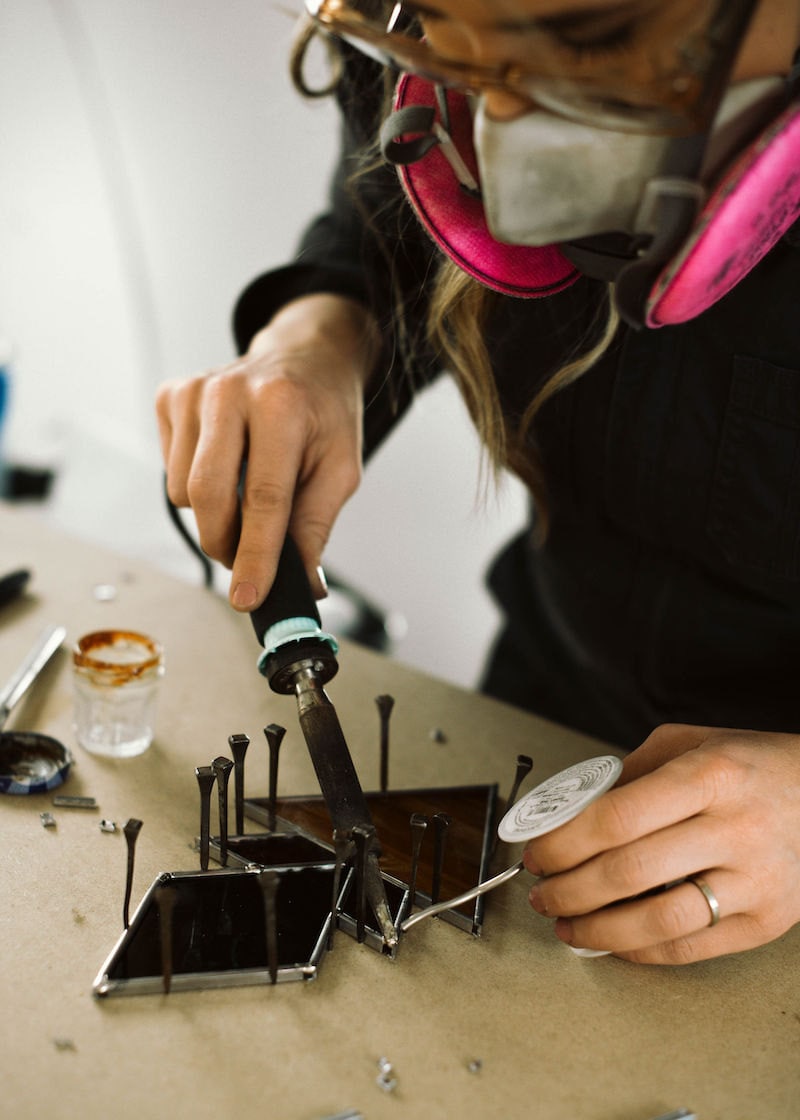 Lauren at work on one of her geometric stained glass pieces