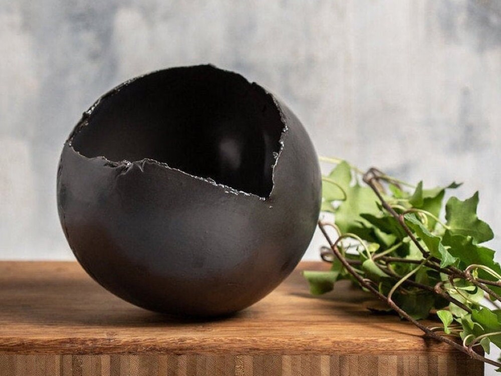 A black ceramic planter from Clay by Dannah