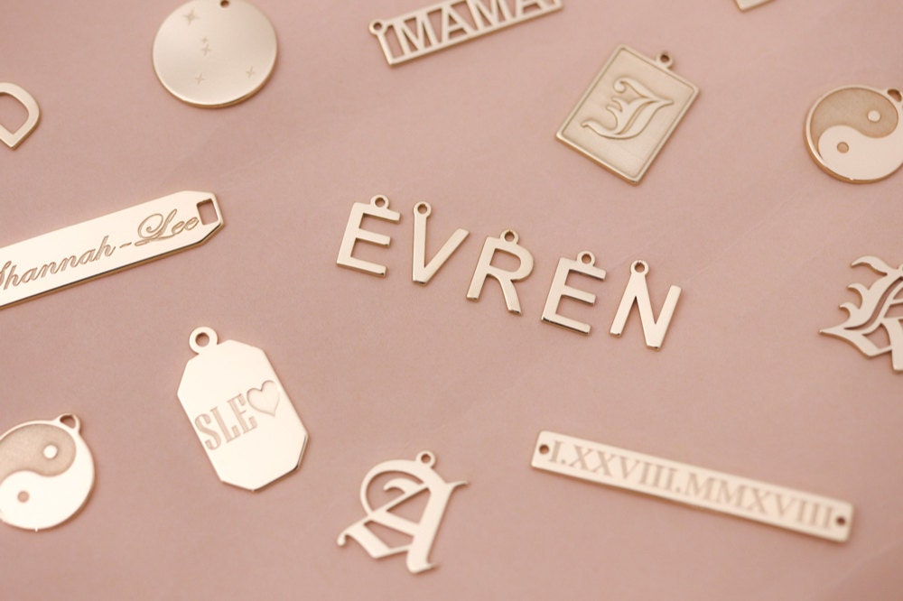 Assorted customized gold charms from EVREN.