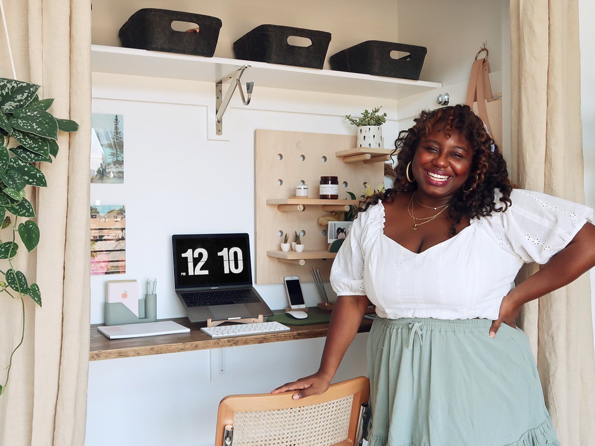 Home and style influencer Janea Brown poses in front of her closet-turned-home office full of fun, functional Etsy finds.