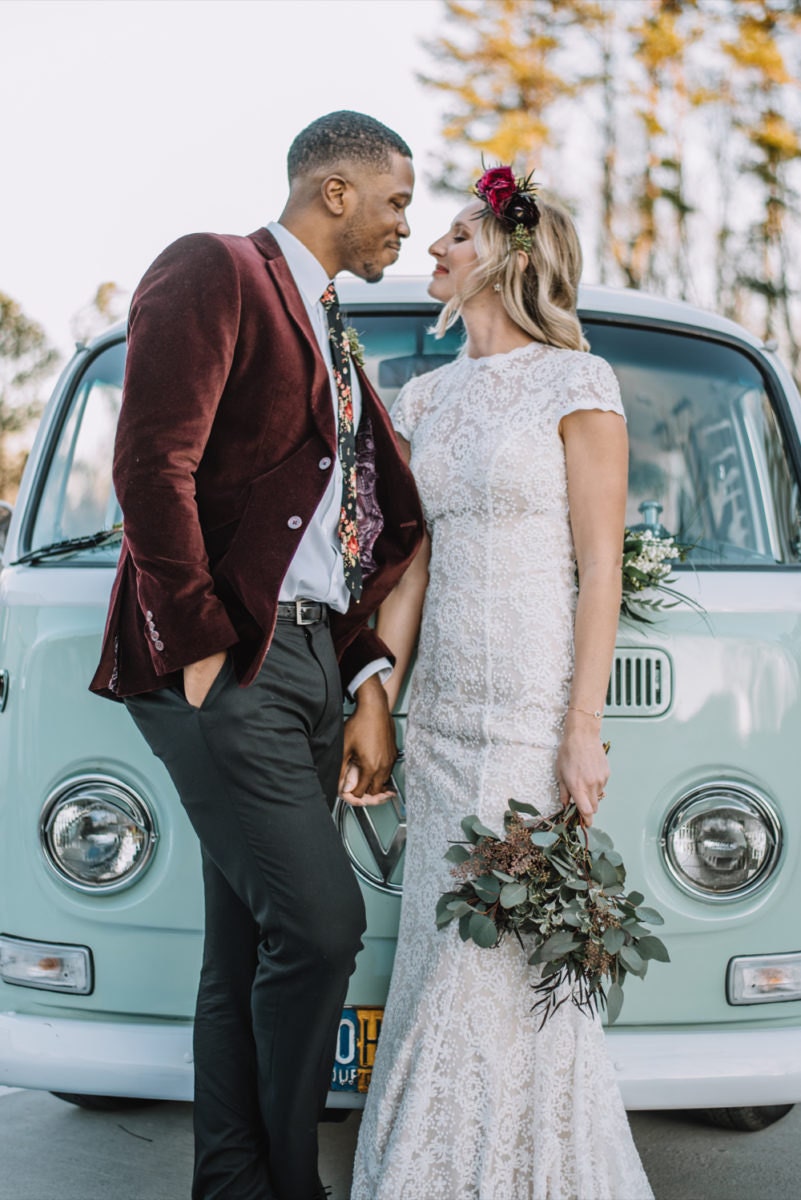 Emily and Terrell pose in front of their mint green van-turned photobooth