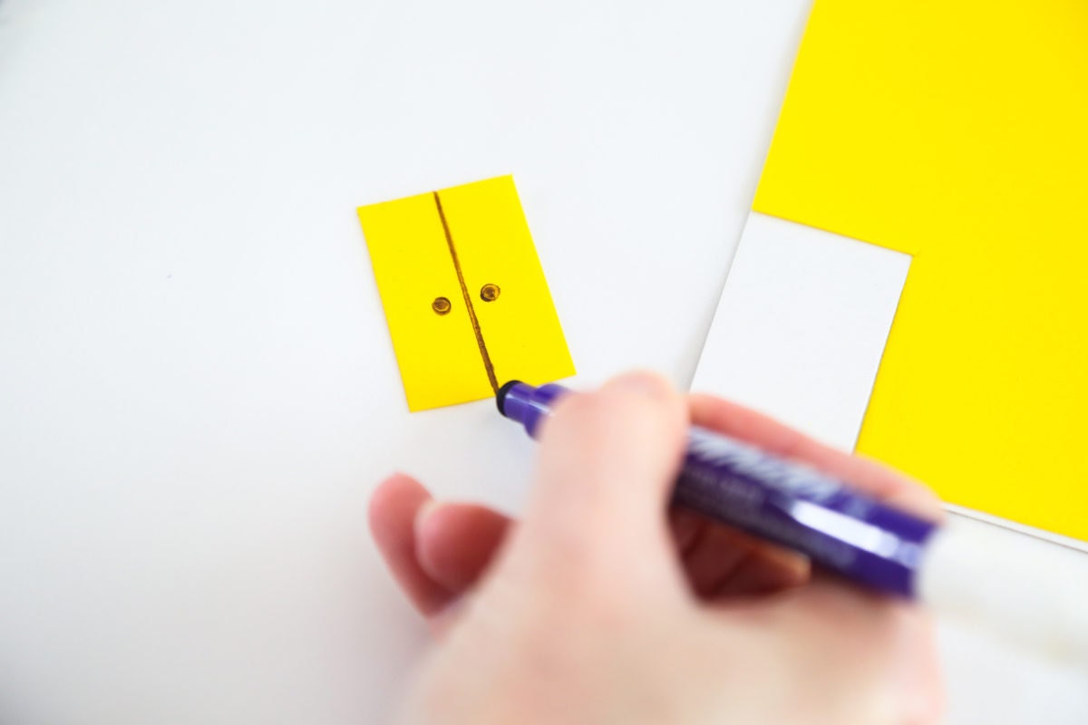 Drawing door details onto a piece of yellow icing.