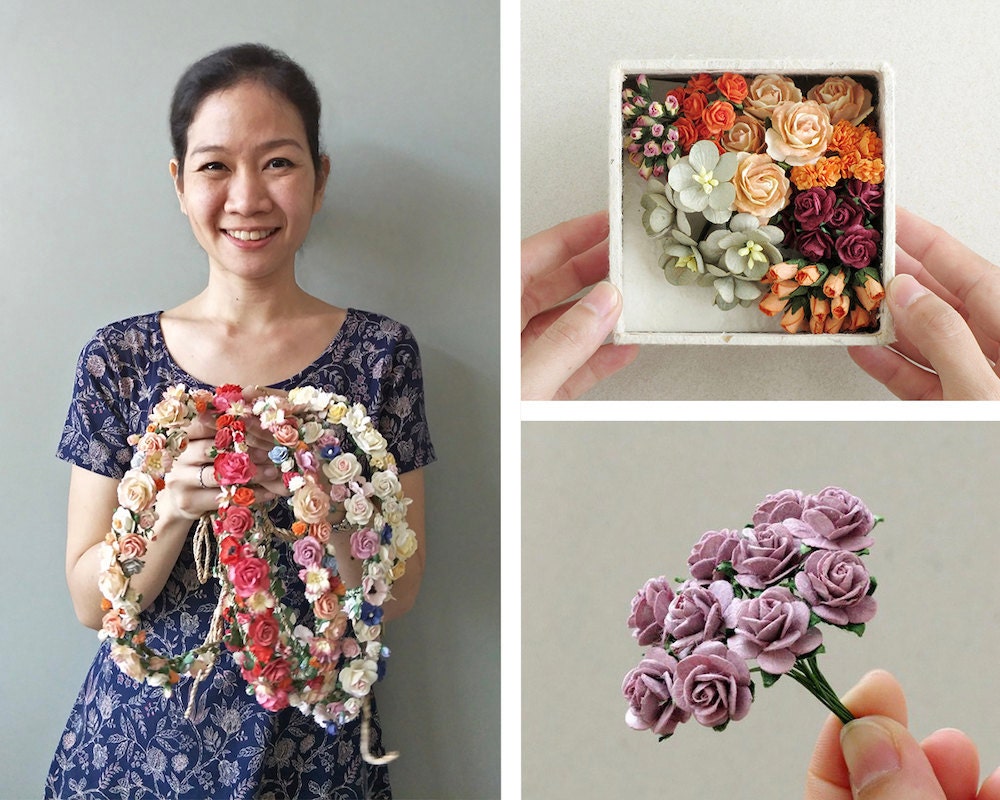 A portrait of craft supply seller Orawee Choedamphai collaged with some miniature paper flowers from her collection