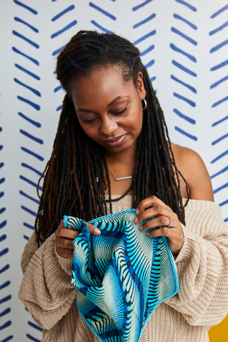 Natalie sews a pillow cover by hand