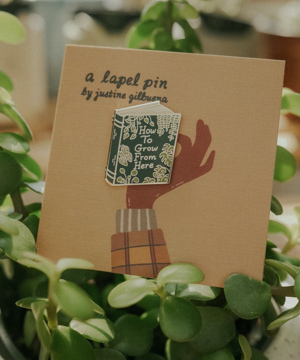 Plant self-care book enamel pin from Justine Gilbuena