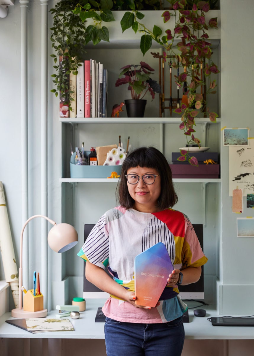 A portrait of Sian holding her Etsy Design Awards Grand Prize.