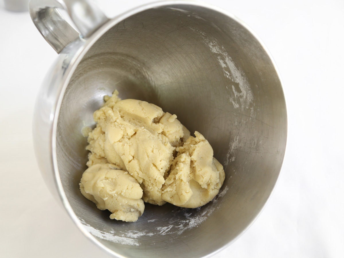 Knead almond pine cone dough until it comes together