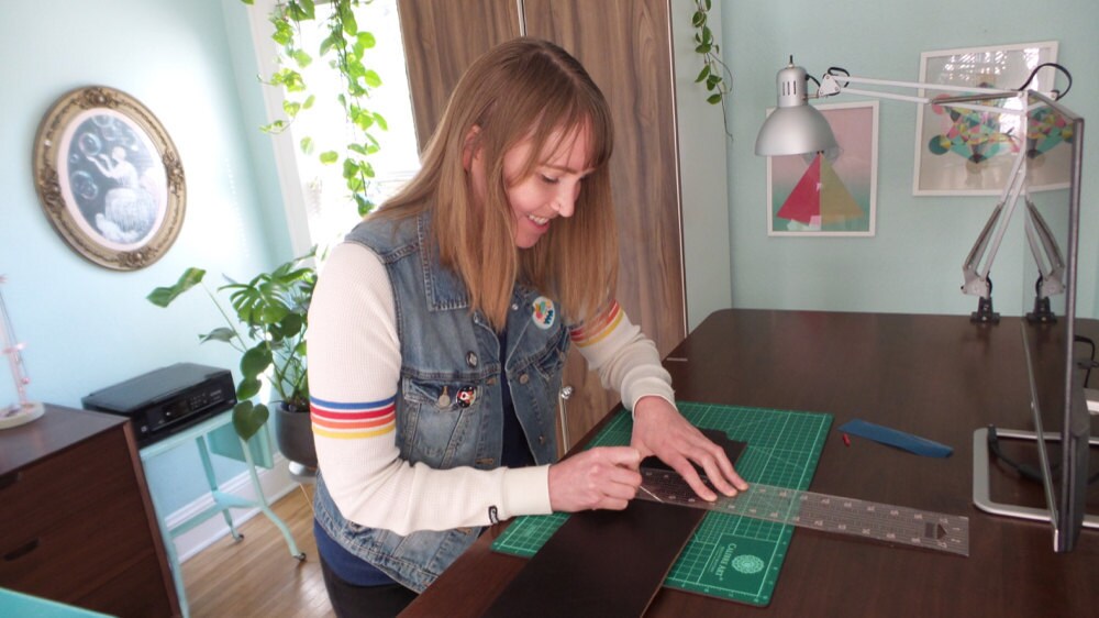 Cutting leather for her straps