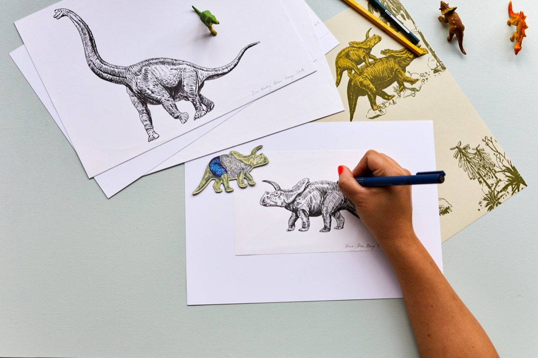 Sian illustrates a triceratops for her award-winning dinosaur wallpaper design.