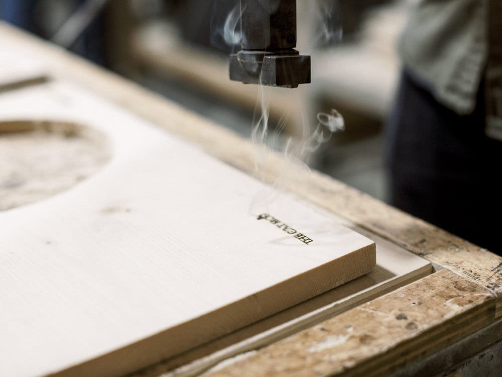 Branding the logo onto a piece of wood