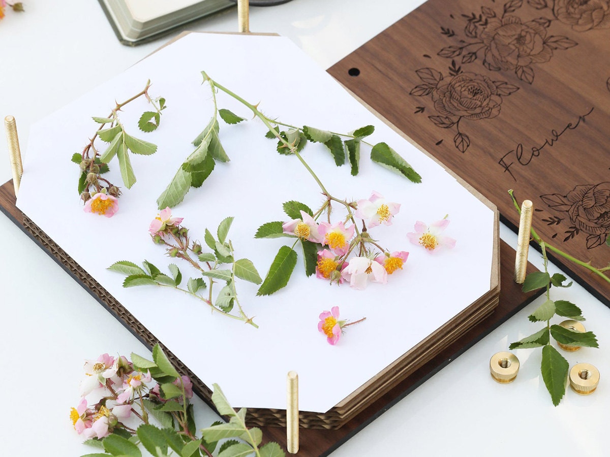 A flower press with flowers inside.