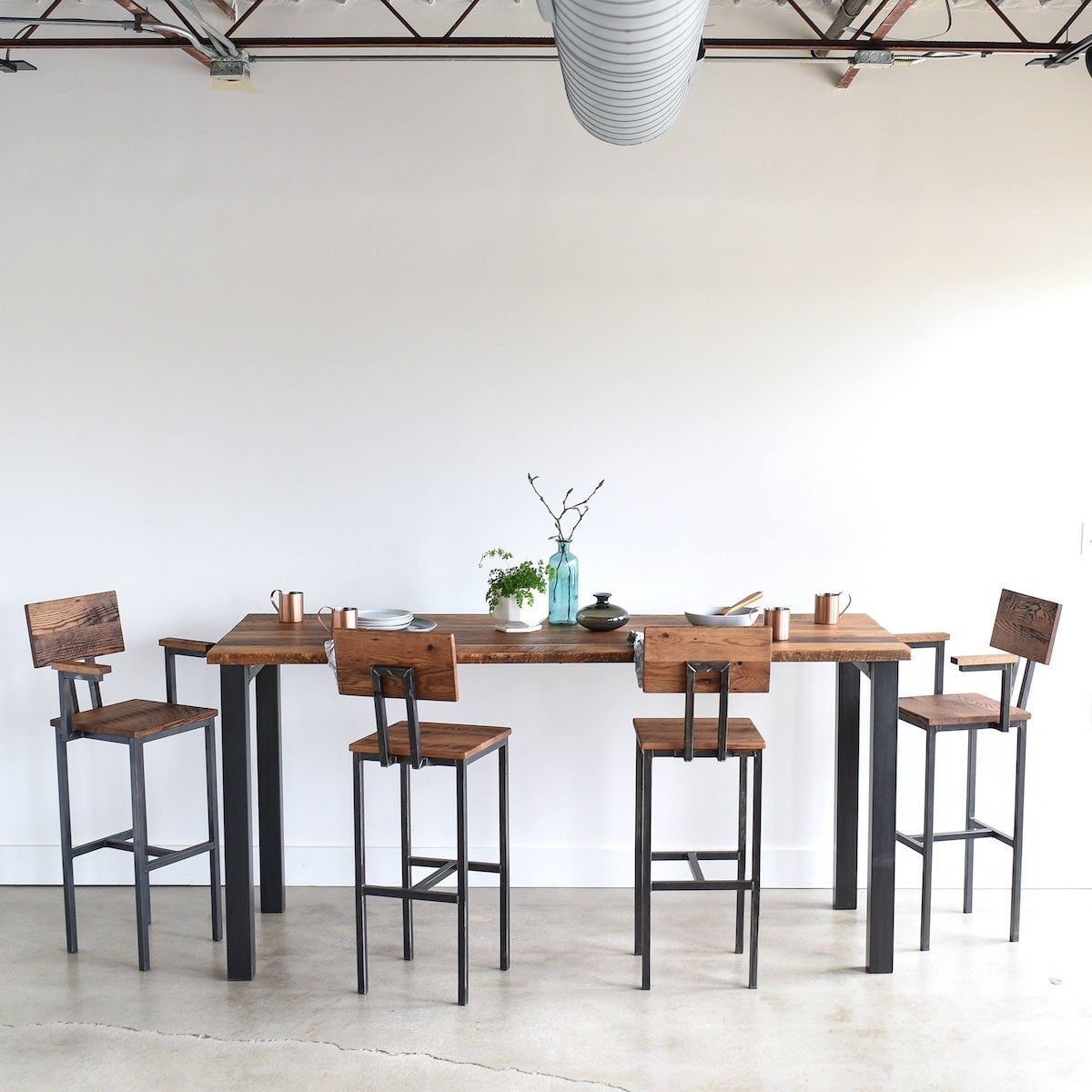 Reclaimed wood pub table and reclaimed wood bar stools from What WE Make