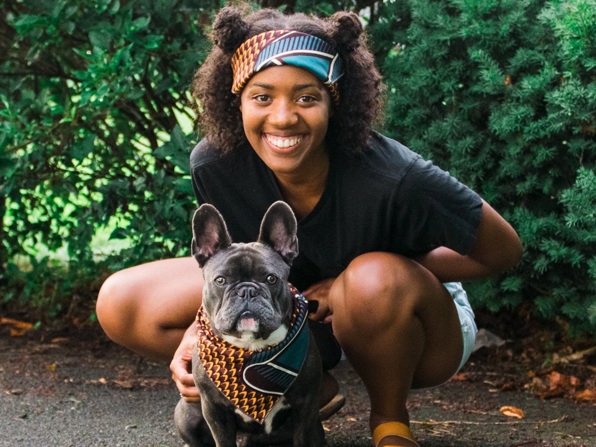 A girl and her dog modeling matching headband and bandana.