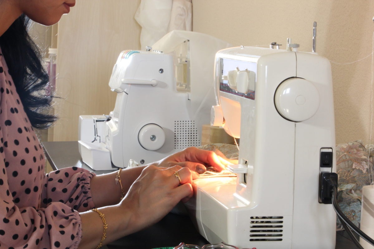 Smitha working at her sewing machine