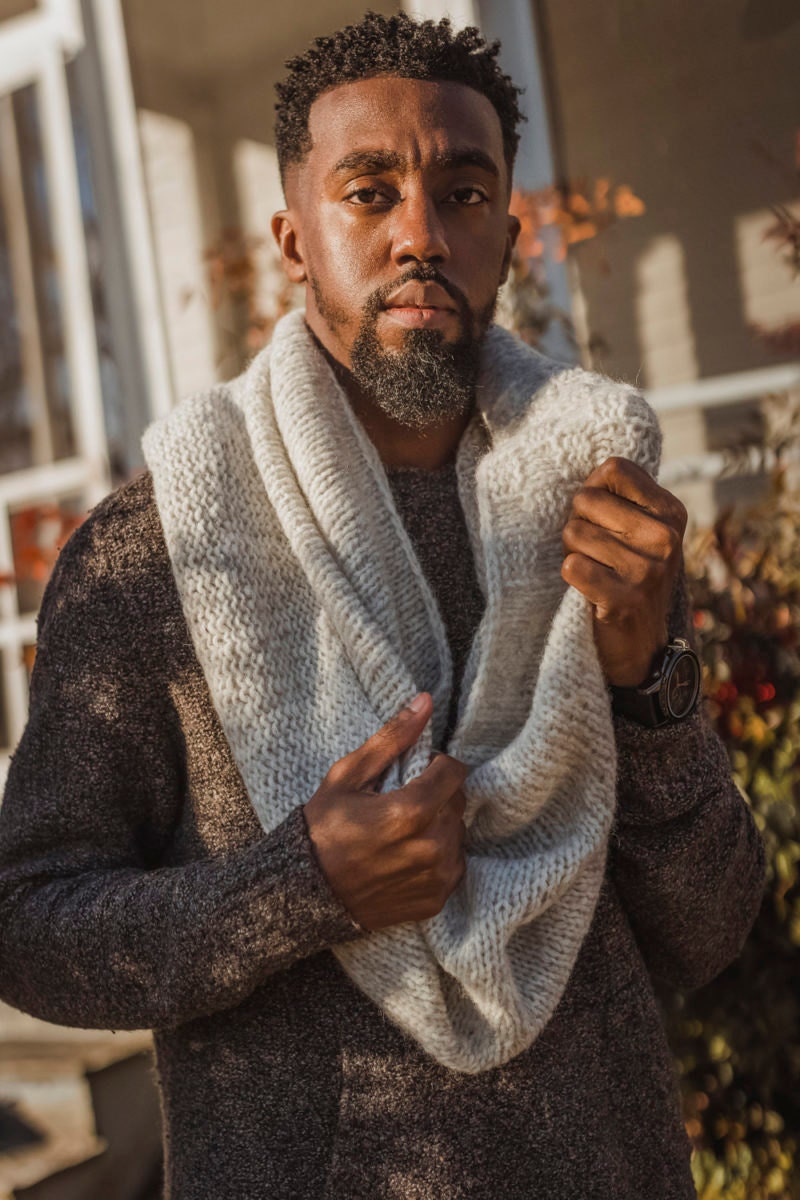 Nathan models a knit cowl—the pattern for which is available for instant download