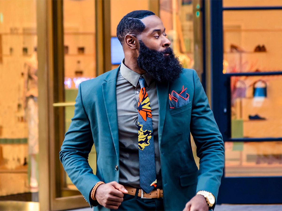 A man wearing a brightly patterned necktie and pocket square from GabeJade