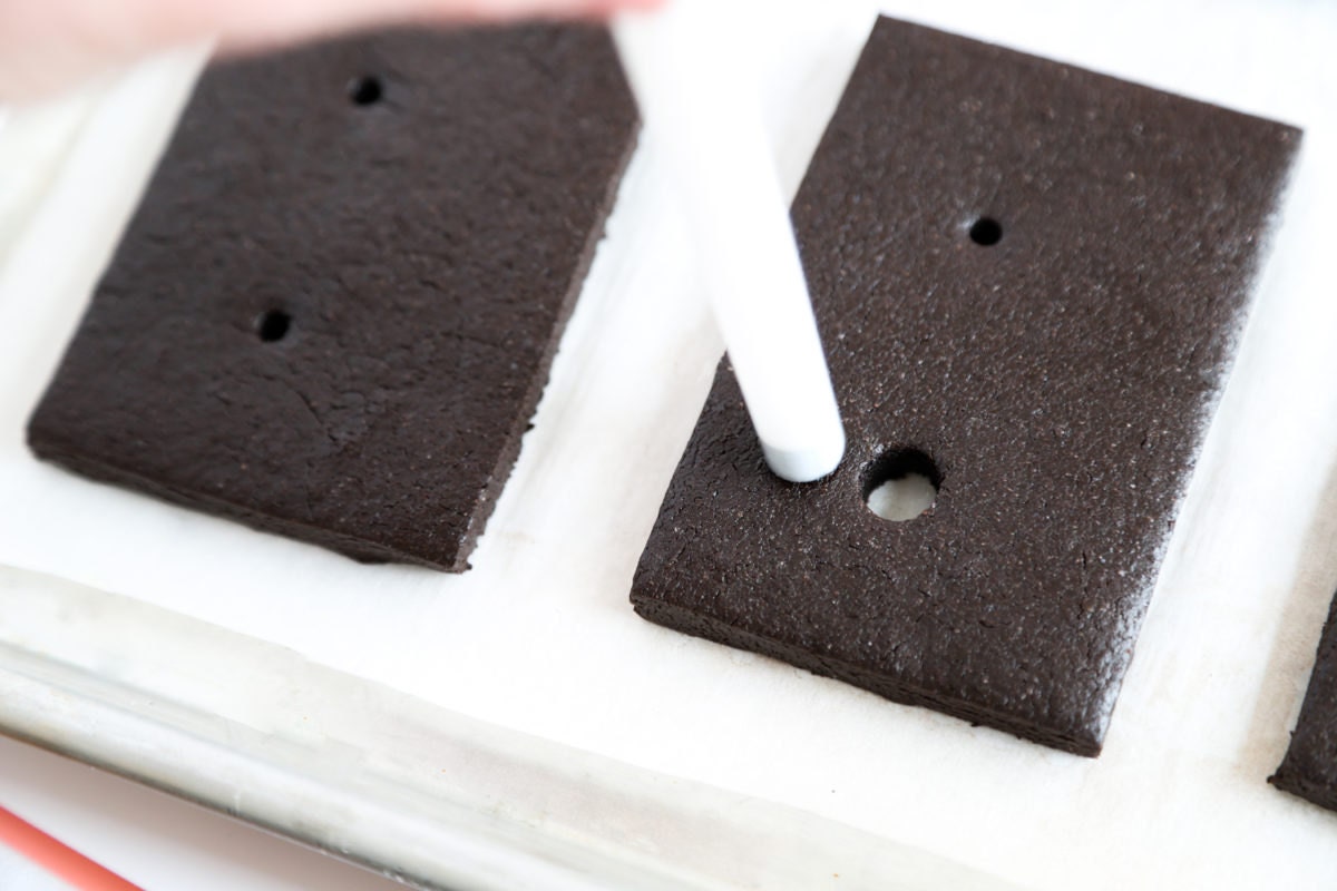 Once the dough has chilled, Heather uses the wide straw to punch out wider holes around the smaller holes.