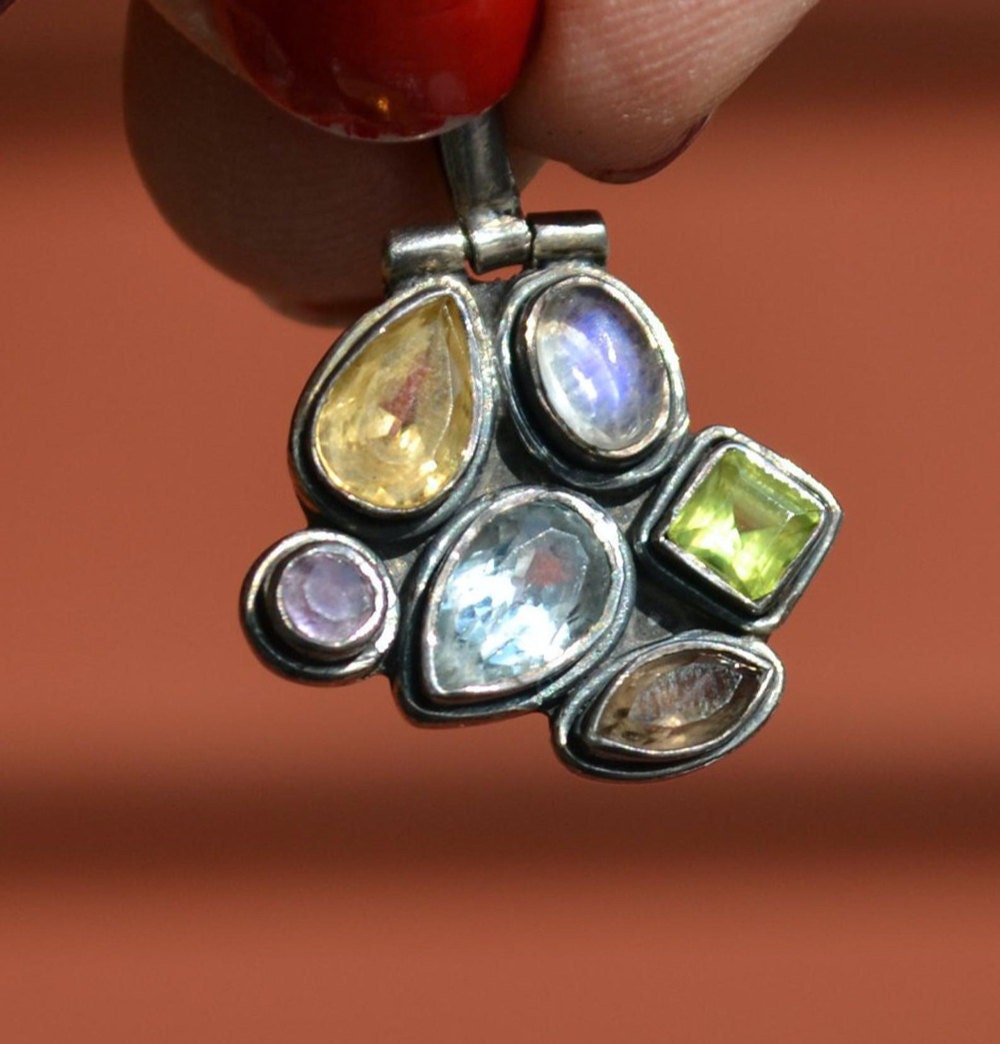 A crystal-studded vintage silver necklace pendant.
