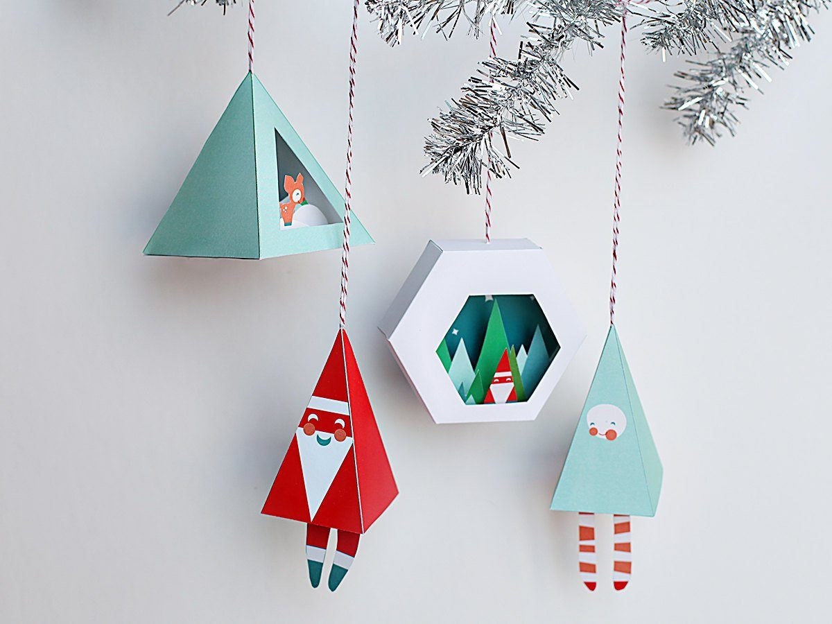 Set of four printable 3D Christmas ornaments hanging from a silver garland