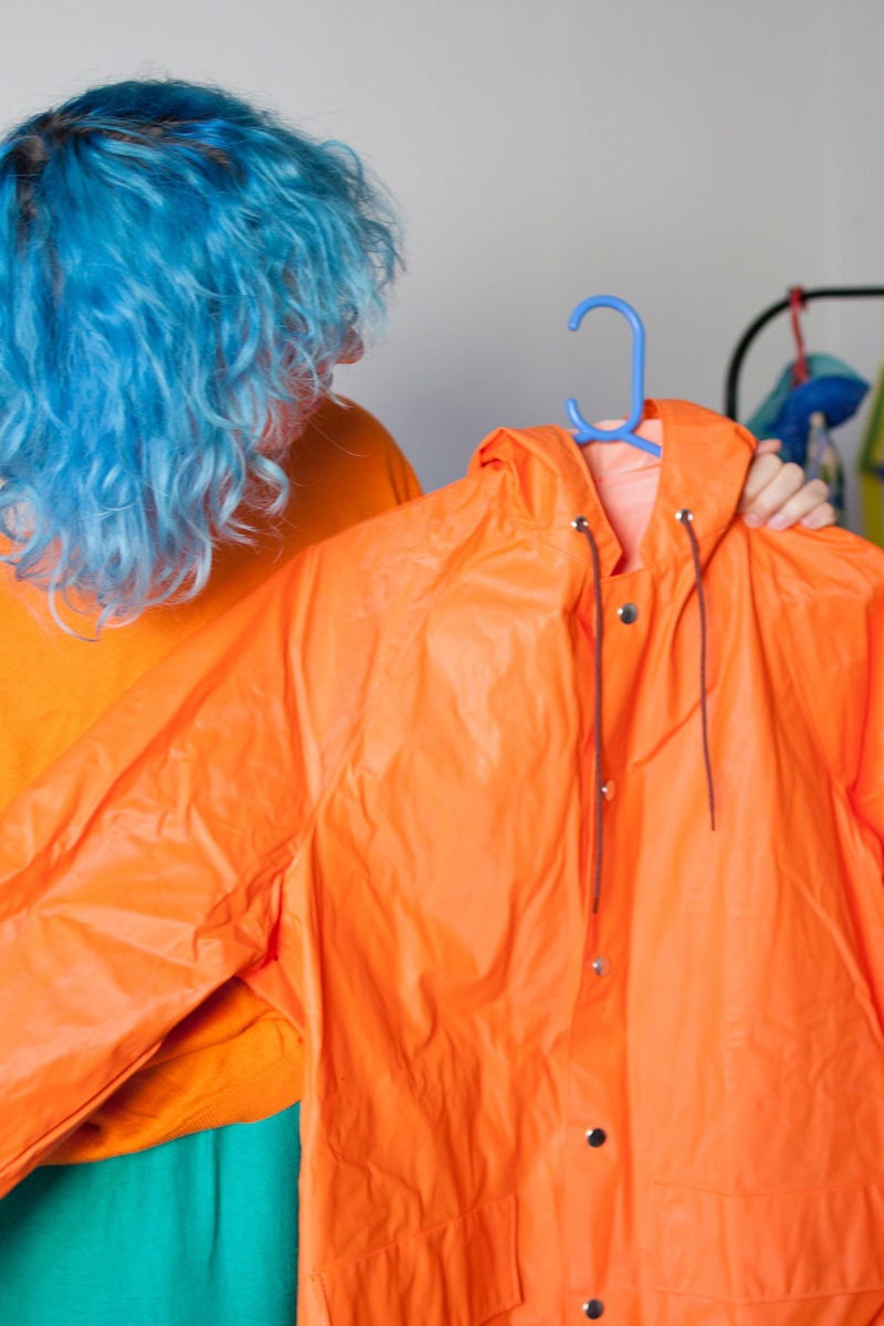 Agnieszka holding an orange rain jacket