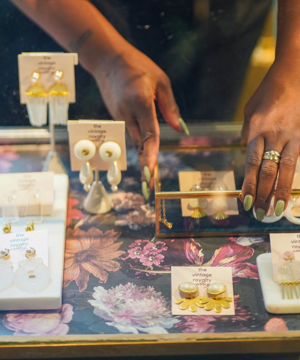 Meena displaying her earrings at a local market