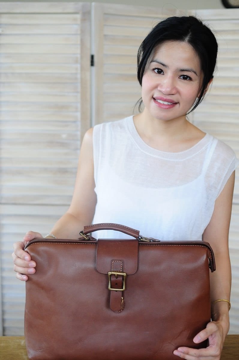 Joe posing with one of her leather doctor bags