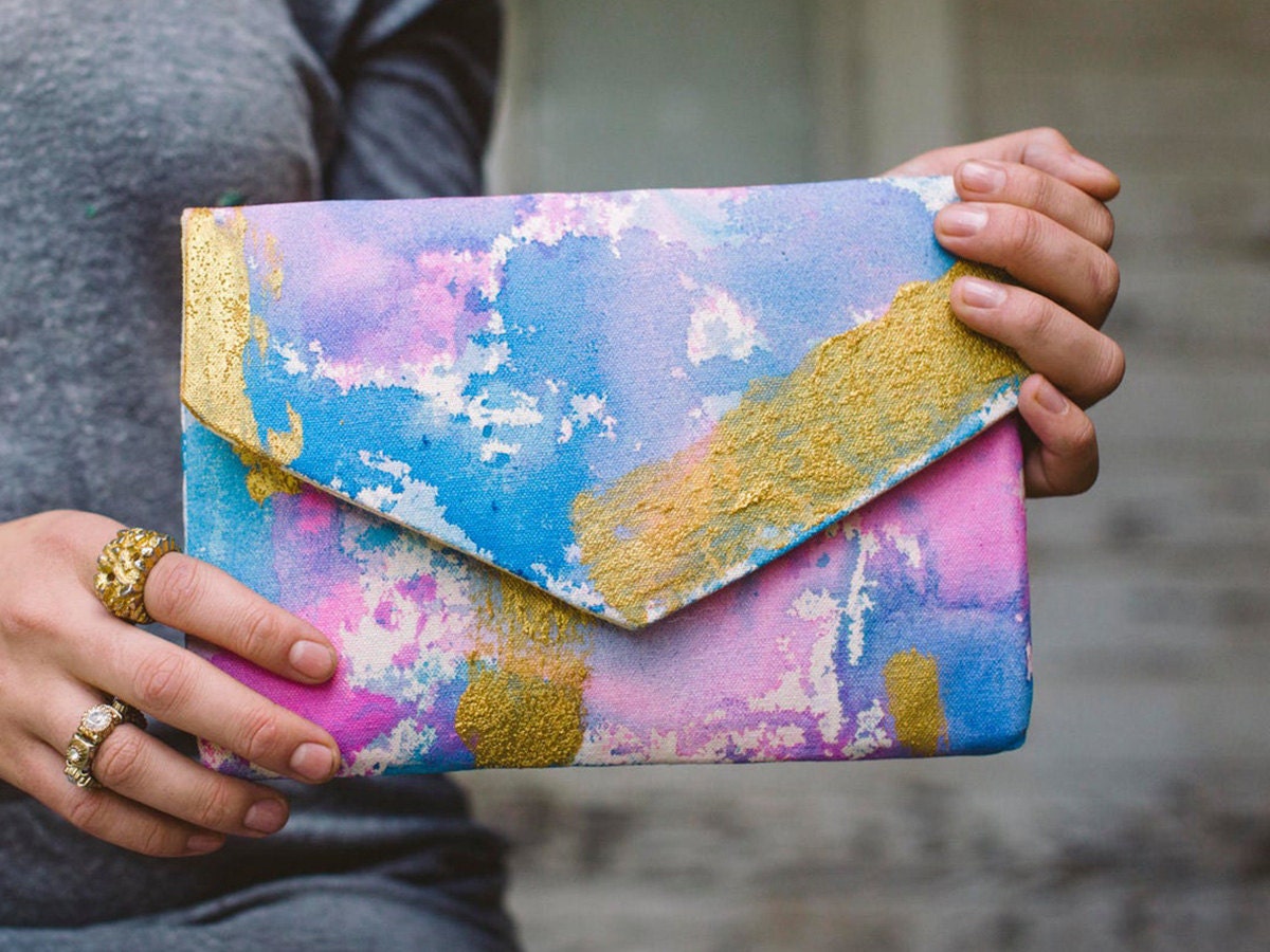 A pastel-colored clutch held by a model.