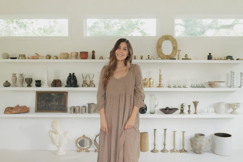 Portrait of Mara Caballero in front of her vintage stock.