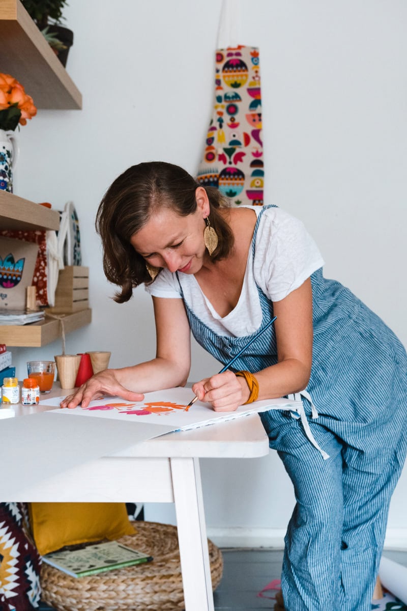 Tatiana painting at her workbench