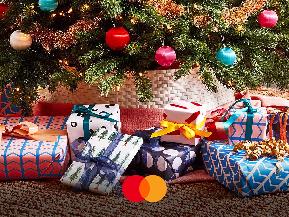 Colorful wrapped presents sitting under a Christmas tree