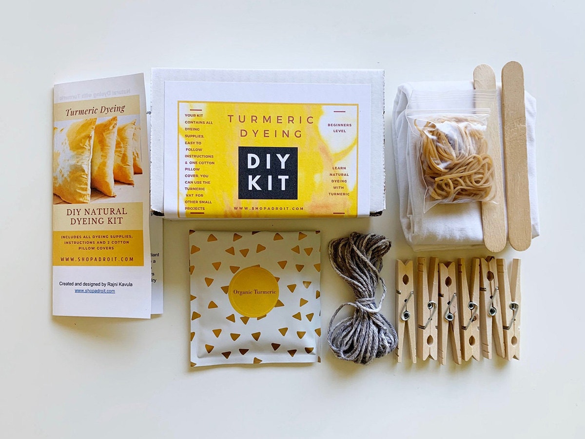 A kit of all the supplies needed to make yellow tie-dye pillows using turmeric.