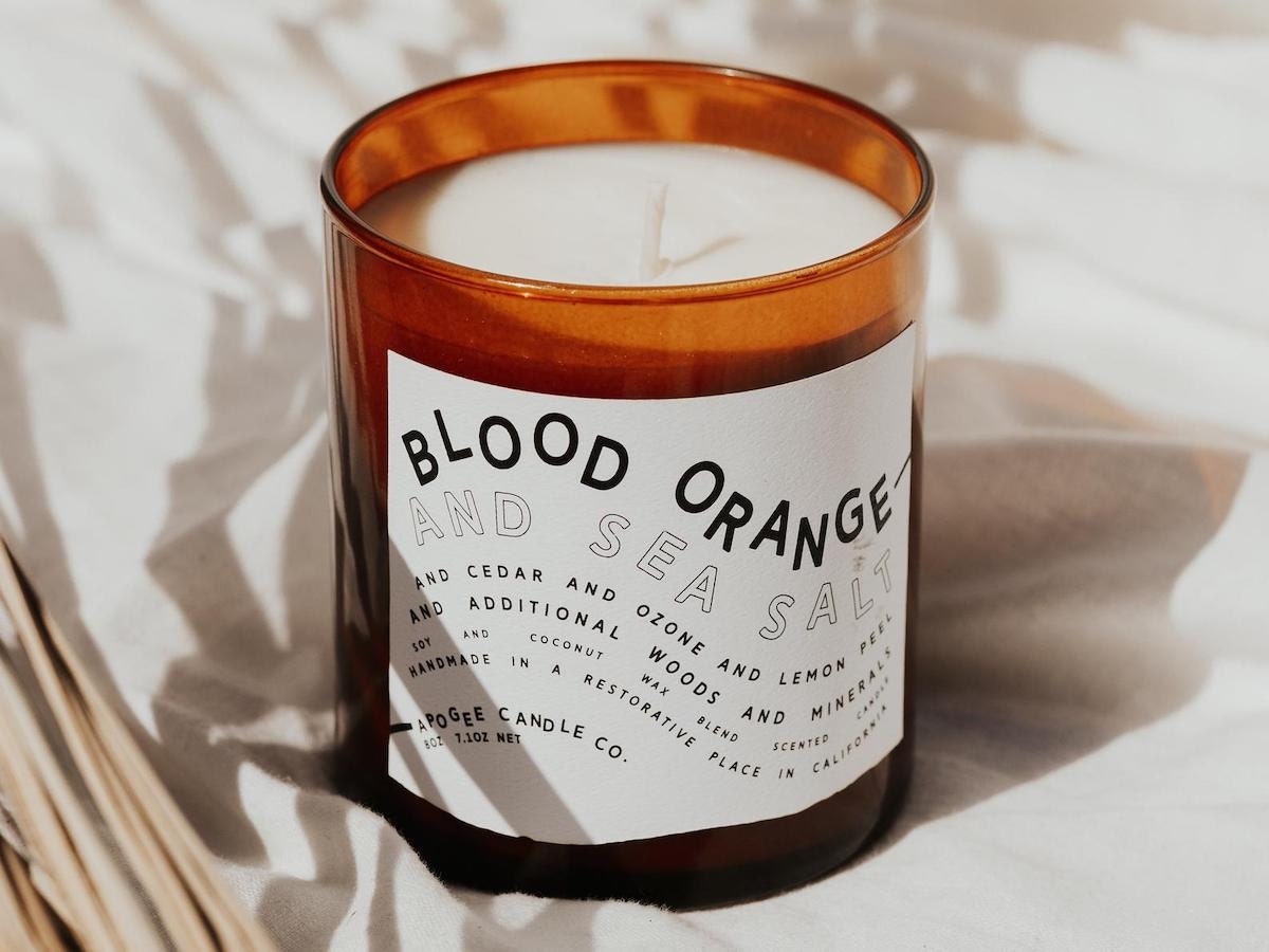 A styled photo of a blood orange candle from Apogee Candle Co.