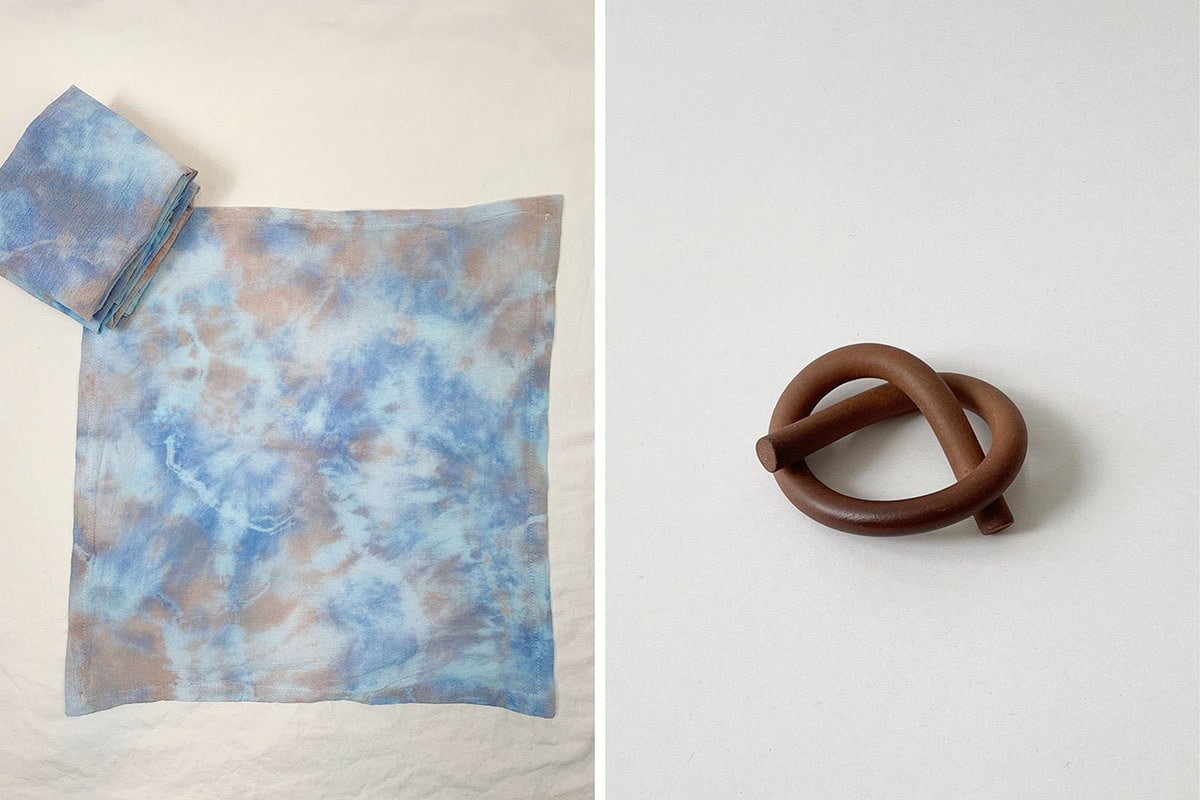 Two images: a blue and grey tie-dye napkin at left and a ceramic napkin holder in the shape of a pretzel at right