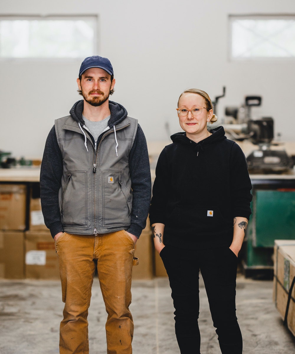 A portrait of WAAM Industries shop owners Andrew and Hanna in their Minnesota workshop.