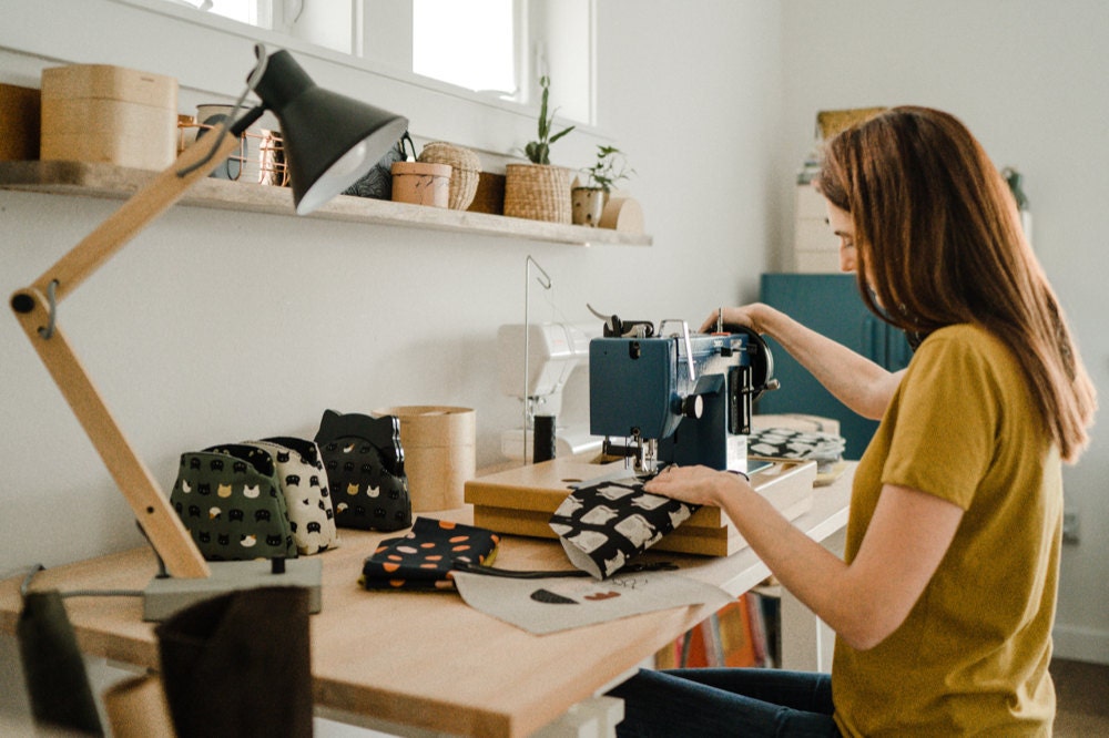 Eda sewing a cat clutch with her sewing machine