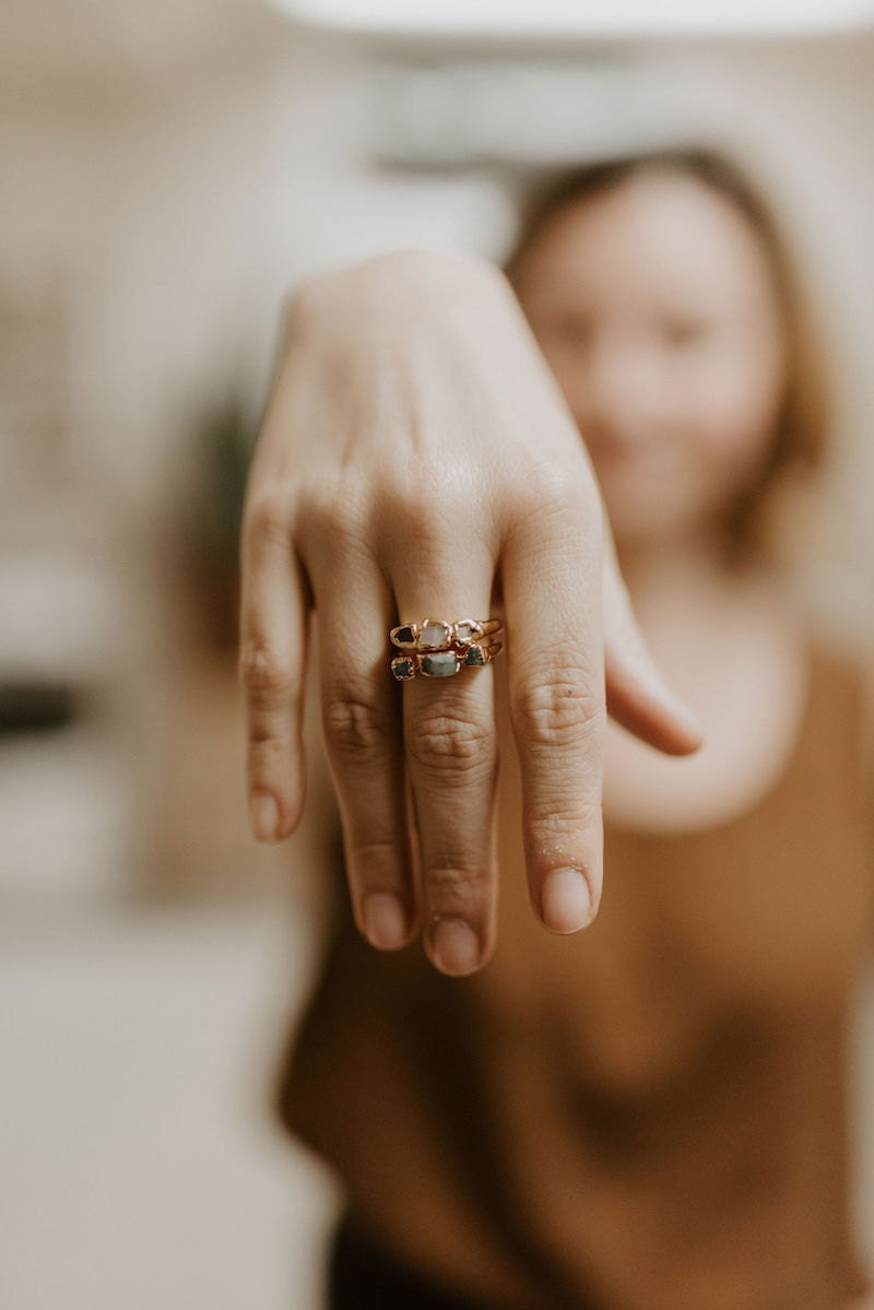 Alicia modeling a stack of rings in her studio